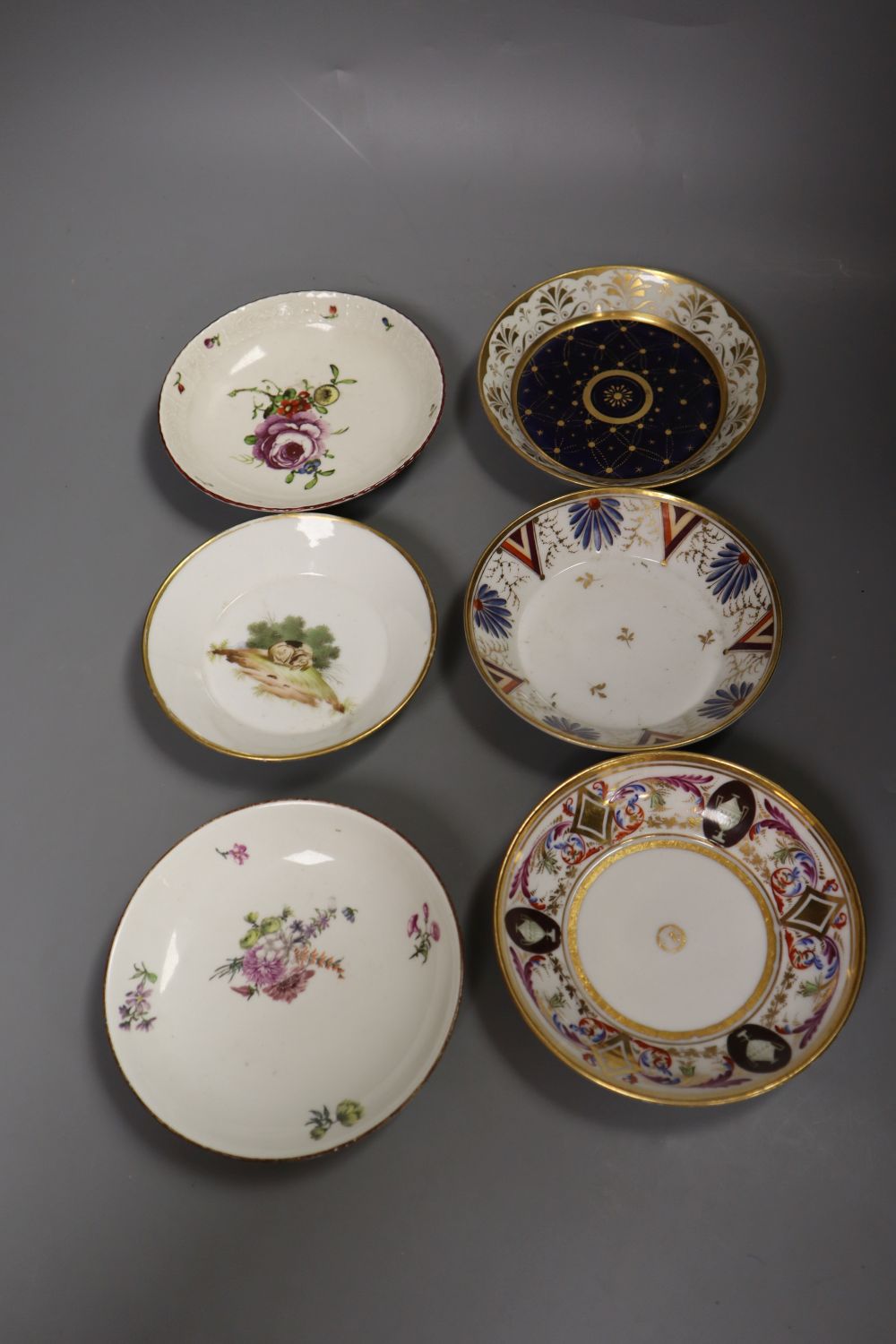 An 18th century Ludwigsburg moulded saucer painted with a large rose and four others